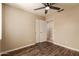 Bedroom with wood-look floors, ceiling fan, closet and attached bath at 4731 N 86Th Dr, Phoenix, AZ 85037