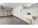 Spacious garage with epoxy flooring, storage shelves, and an automatic door opener at 4731 N 86Th Dr, Phoenix, AZ 85037