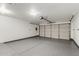 Clean, well-lit garage with epoxy flooring, storage shelves, and an automatic door opener at 4731 N 86Th Dr, Phoenix, AZ 85037