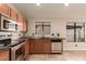 This kitchen features stainless steel appliances, wood cabinets, and a sink under a window at 4731 N 86Th Dr, Phoenix, AZ 85037