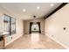 Open-concept living room with bright walls, tile flooring, recessed lighting, and sliding glass doors to the backyard at 4731 N 86Th Dr, Phoenix, AZ 85037