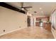 Spacious living room with tile flooring, modern ceiling fan, and natural light at 4731 N 86Th Dr, Phoenix, AZ 85037