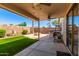 Relaxing covered patio with outdoor kitchen, fire pit, and artificial turf at 4731 N 86Th Dr, Phoenix, AZ 85037
