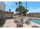 Charming backyard with ample seating, a tiled pool surround, and mature landscaping at 4812 W Butler Dr, Chandler, AZ 85226