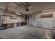 Spacious garage featuring ample storage, shelving, and a convenient utility sink at 4812 W Butler Dr, Chandler, AZ 85226