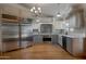 Modern kitchen with stainless steel appliances, custom cabinets, and granite countertops at 4812 W Butler Dr, Chandler, AZ 85226