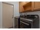 Functional laundry room with appliances, cabinetry, and a convenient door for easy access at 4812 W Butler Dr, Chandler, AZ 85226
