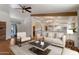 Bright living room with a ceiling fan, hardwood floors, and seamless flow to the kitchen at 4812 W Butler Dr, Chandler, AZ 85226