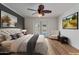 This bedroom features a ceiling fan, wood floors, access to the pool, and tasteful decor at 4812 W Butler Dr, Chandler, AZ 85226