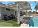 Inviting patio area with comfortable seating, an outdoor spa, and a shaded pergola at 4812 W Butler Dr, Chandler, AZ 85226