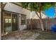 Cozy backyard featuring sliding door access to the home, a small window, and a shaded tree at 503 N Ranger Trl, Gilbert, AZ 85234