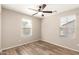 Bedroom with ceiling fan and two windows providing natural light at 503 N Ranger Trl, Gilbert, AZ 85234