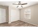 Bedroom boasts modern ceiling fan, wood-look floors, and a sliding-door closet for ample storage at 503 N Ranger Trl, Gilbert, AZ 85234