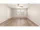 Bright bedroom with wood-look floors, a ceiling fan and neutral walls bathed in natural light at 503 N Ranger Trl, Gilbert, AZ 85234
