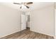 Empty bedroom featuring wood-look floors, ceiling fan, and a doorway to the hallway at 503 N Ranger Trl, Gilbert, AZ 85234