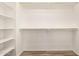 Walk-in closet with white shelving on the left and chrome rods at 503 N Ranger Trl, Gilbert, AZ 85234