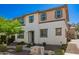 Stylish two-story house with tan and white exterior paint scheme and professionally landscaped front yard at 503 N Ranger Trl, Gilbert, AZ 85234