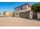 Two-story home featuring a two-car garage, a driveway made from decorative brick, and desert landscaping at 503 N Ranger Trl, Gilbert, AZ 85234