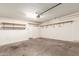 Spacious garage with overhead lighting, shelving and door to the main house at 503 N Ranger Trl, Gilbert, AZ 85234