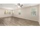 Sun-filled living room boasts hardwood floors and large windows, creating a warm and inviting ambiance at 503 N Ranger Trl, Gilbert, AZ 85234