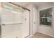 Shower features a clear glass sliding door, white tile surround and a shower head at 503 N Ranger Trl, Gilbert, AZ 85234