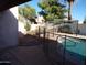 Relaxing backyard featuring a refreshing private pool, mature trees, and shaded seating area at 5323 W North Ln, Glendale, AZ 85302