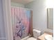 Bright bathroom with a shower-tub combo and unicorn-themed shower curtain at 5323 W North Ln, Glendale, AZ 85302