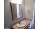 Well-lit bathroom featuring a vanity with countertop sink, mirror, and light blue walls at 5323 W North Ln, Glendale, AZ 85302