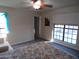 Well lit bedroom featuring a ceiling fan and a large window at 5323 W North Ln, Glendale, AZ 85302