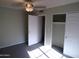 Bedroom with closet, ceiling fan, carpet and light colored walls at 5323 W North Ln, Glendale, AZ 85302