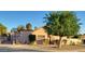 Charming single-story home with mature landscaping and a basketball hoop in the front at 5323 W North Ln, Glendale, AZ 85302
