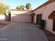 Single story home featuring an attached garage and desert landscaping at 5323 W North Ln, Glendale, AZ 85302