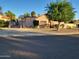 Exterior of home with desert landscaping, secure gate, and basketball hoop near the driveway at 5323 W North Ln, Glendale, AZ 85302