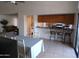 Eat-in kitchen with bar seating, stainless refrigerator, and tile flooring at 5323 W North Ln, Glendale, AZ 85302