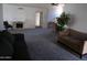 Spacious living room with neutral carpet, fireplace, and ample seating at 5323 W North Ln, Glendale, AZ 85302