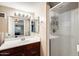 Cozy bathroom featuring dark wooden cabinets, a shower and modern fixtures at 5734 S 21St Pl, Phoenix, AZ 85040