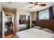 Spacious bedroom featuring a large window with wood trim and a closet with mirrored doors at 5734 S 21St Pl, Phoenix, AZ 85040