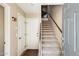 Welcoming entryway with carpeted stairs and a spiral staircase, featuring a secure alarm system and front door at 5734 S 21St Pl, Phoenix, AZ 85040