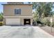 Exterior shot of home and garage, showcasing a spacious driveway and attractive architectural details at 5734 S 21St Pl, Phoenix, AZ 85040