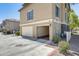 Exterior view of a three-car garage, offering ample parking space and convenient access at 5734 S 21St Pl, Phoenix, AZ 85040
