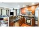 Well-appointed kitchen with dark wood cabinets, granite countertops, stainless steel appliances, open to living space at 5734 S 21St Pl, Phoenix, AZ 85040