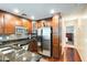 Well-lit kitchen featuring stainless steel appliances, granite countertops, and dark wood cabinets at 5734 S 21St Pl, Phoenix, AZ 85040