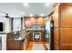 Modern kitchen boasts dark wood cabinets, granite countertops, and stainless steel appliances for a luxurious feel at 5734 S 21St Pl, Phoenix, AZ 85040