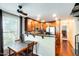 Charming kitchen with dark wood cabinets, granite countertops, stainless steel appliances, and adjacent dining area at 5734 S 21St Pl, Phoenix, AZ 85040