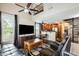Open concept living room featuring a spiral staircase, ceiling fans, and hardwood floors at 5734 S 21St Pl, Phoenix, AZ 85040