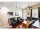 Stylish living room featuring vaulted ceilings, hardwood floors, and comfortable seating with picturesque wall art at 5734 S 21St Pl, Phoenix, AZ 85040