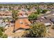 A tranquil neighborhood is showcased with various homes, mature trees, and quiet streets on a sunny day at 6015 W Acoma Dr, Glendale, AZ 85306