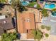 Overhead shot displaying the house, an enclosed backyard, and surrounding neighborhood pools and foliage at 6015 W Acoma Dr, Glendale, AZ 85306