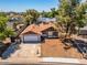 Aerial view of a single-story home with a spacious yard and a two car garage at 6015 W Acoma Dr, Glendale, AZ 85306