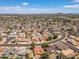 Captured aerially, a community displays multiple houses, winding streets, and vibrant vegetation at 6015 W Acoma Dr, Glendale, AZ 85306